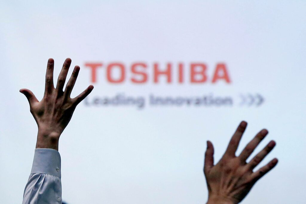 FILE PHOTO: Reporters raise their hands for a question during a Toshiba news conference at the company headquarters in Tokyo, Japan, June 23, 2017. REUTERS/Issei Kato/File Photo